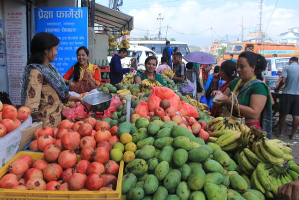 A group of women buy fruits at Satdobato Chowk on Monday. More fruits are sold on Mondays during the month of Shravan when women fast.