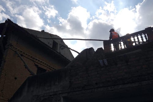 A joint team of Nepal Army and Armed Police Force demolishes a house damaged by the earthquake in Katunje, Bhaktapur on Friday.