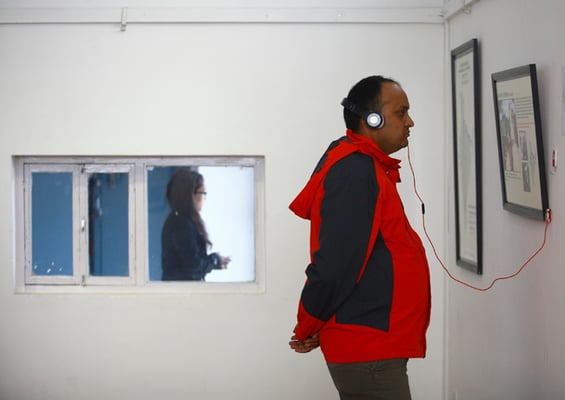 A man observes an audio and visual exhibition ‘So Far From Home: Nepali Migrants Tell Their Stories’ in Nepal Art Council on Tuesday. Organised by six Nepali and international organisations, the exhibition will run until 10 December.