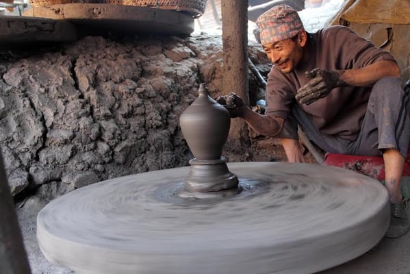 POTTER MAGIC: A potter putting finishing touches in his pot at Bhaktapur on Monday.