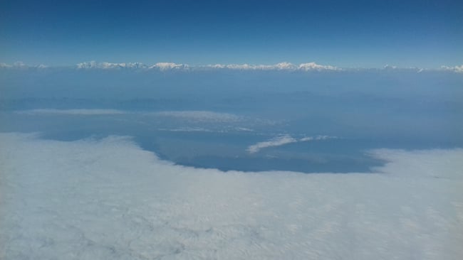 A thick blanket of fog covers the Nepal Tarai in this photograph taken on Sunday morning from a flight approaching Kathmandu. Chitwan Valley is clear of fog with the Annapurnas on the horizon.