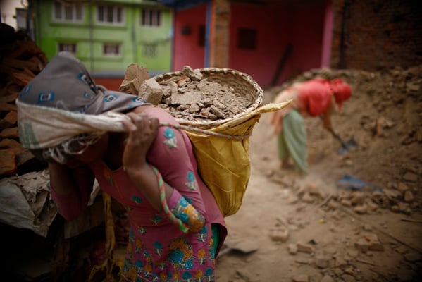 Bimala Tamang, 39 of Okhaldhunga works at a construction site to rebuild a house destroyed by last year's earthquake on Sunday.