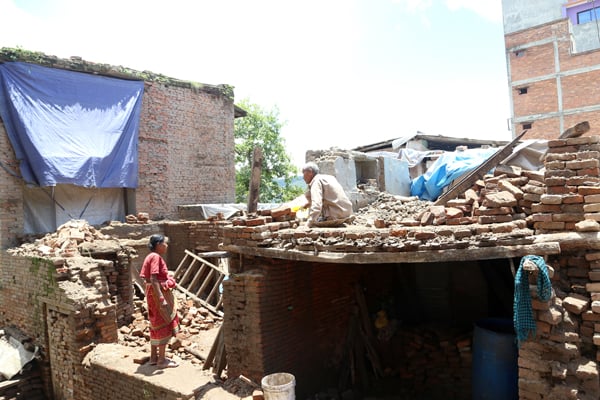 An elderly couple working to rebuild their house in Sankhu, Kathmandu on Monday.