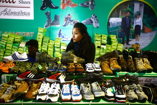 A stall owner awaits visitors at the ongoing Footwear Business Expo at Bhrikuti Mandap on Wednesday.