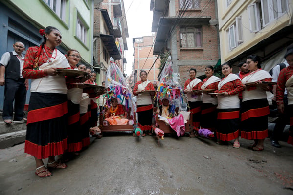 77-year-old Nati Maharjan and his wife Laxmi Kumari Maharjan take a tour of the town in their chariots pulled by their family to celebrate their first 'Janku' in Mikha Bahal, Patan on Thursday. Janku is a celebration performed when a person of Newar community reaches a certain age.