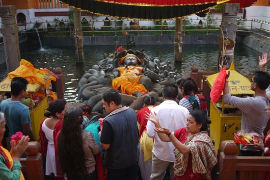 People queue up to pay their offerings to Lord Vishnu at the Budhanilkantha temple on Wednesday morning.