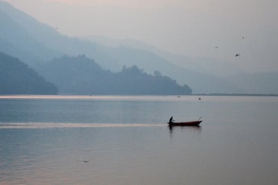 THE LONG DAY WANES: A boatsman rows back to shore after yet another day of showing tourists around Phewa lake in Pokhara.