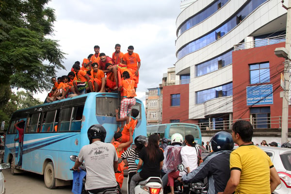 Bol Bom devotees getting on a bus and creating a jam in Sundhara on Sunday.