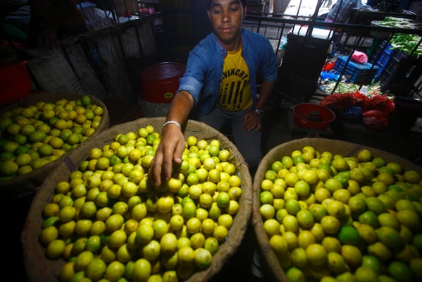 A vegetable vendor sells lemons at Kalimati. Vegetable prices have soared in Kathmandu since the earthquake.