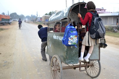 BOARDING SCHOOL: Children are ferried in a muscle-powered cart on the Surkhet-Nepalganj highway on Tuesday afternoon.
