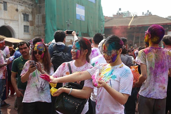 Denizens of Kathmandu celebrate Holi, the“festival of colors” to mark the beginning of spring at Basantapur on Thursday.