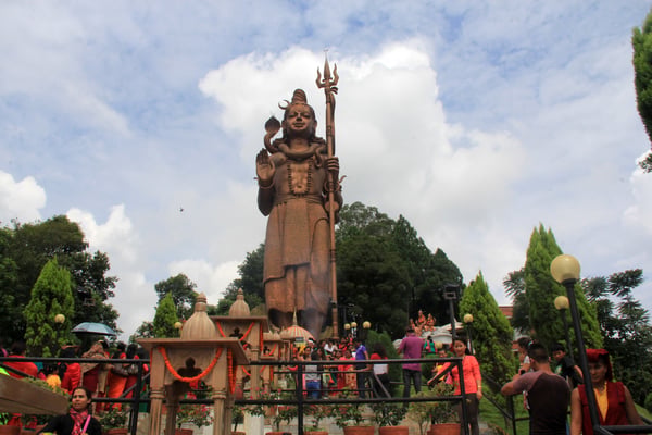 Devotees gather around the statue of Lord Shiva at Sanga Banjhyang on Monday.