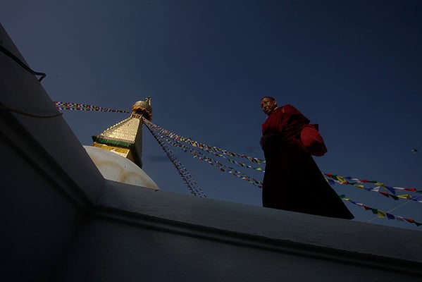 A monk circumambulates the Boudhanath Stupa on Friday. The Stupa which sustained damage during the April 2015 earthquake will formally re-open on 22 November after the completion of reconstruction works.