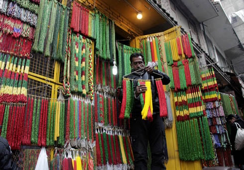 INCREASE IN BUSINESS: With wedding season in full swing, a shopkeeper arranges bead necklaces on sale at New Road.