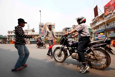 GIVE ME THE KEYS: Protestors stop a motorbike and demand the keys of the vehicle during the bandh at Kalimati on Sunday.