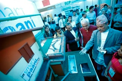 THE GREEN LIFE: Chief Secretary Lila Mani Paudel (centre) visits stalls at Nepali Times Eco Fair in Academy Hall, Kamaladi on Wednesday.
