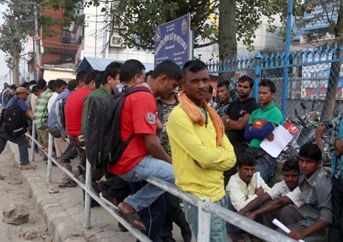 Nagendra Mahato of Sarlahi district queues up outside Maharajganj police office on Thursday to apply for a police report -- a document necessary for going abroad. As violence protests over the draft constitution continue in the Tarai, more Madhesi youths are now coming to Kathmandu to migrate to the gulf.