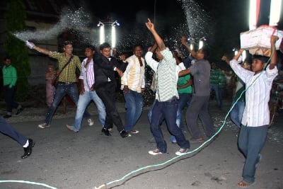LIGHTING THE PARTY: Male relatives of a wedding couple dance on the road during a Hindu wedding procession on Wednesday night in Letang.