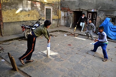 SUPER SIXES: Never mind the cramped space, children play cricket inside a courtyard in Patan on Monday.