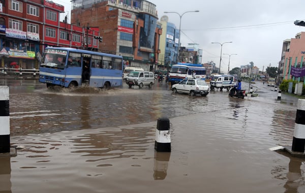 Vehicles wade through a flooded street in Tinkune, Kathmandu on Wednesday morning. Lack of proper drainage system has made it difficult for vehicles to pass through streets in Kathmandu in rainy season.