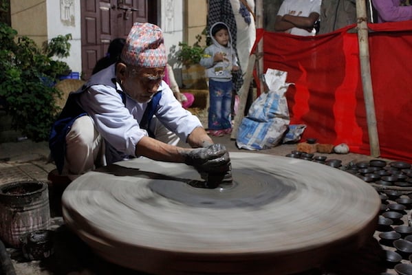 Mohan Singh Prajapati, a member of Jyapu community demonstrates his traditional occupation of pottery making during this week's festival in Patan on Wednesday. 80-year-old Prajapati has been in the profession for almost seven decades.