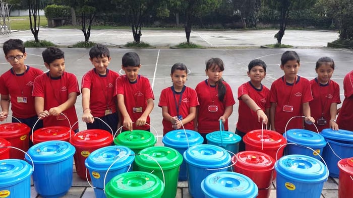Grade 3 students of a school in Kathmandu on Wednesday ready buckets with food and other essentials for delivery to families affected by floods in mid-western Nepal.