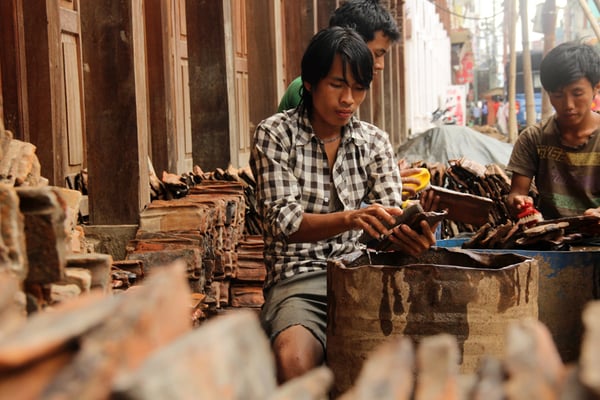 Workers clean bricks brought in from Bhaktapur to Basantapur on Tuesday.