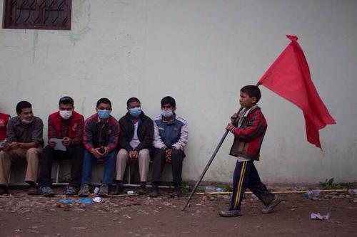 A child carries a Maoist flag during the rally called by the 30 party alliance at Tundikhel on Saturday.