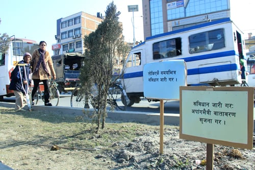 Signboards demanding the timely drafting of the constitution are placed in traffic islands in New Baneswor.