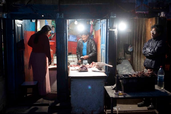 MID-NIGHT DINNER: A butcher in Basantapur packs meat for last minute customers on Monday night.