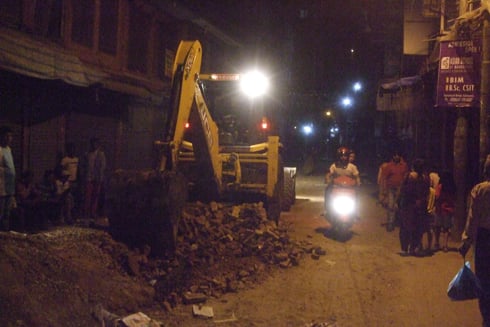 SWEEPING OVERTIME: An excavator prepares a street in Ason for blacktopping. Indra Jatra is on 18 September and the chariot passes through this route.