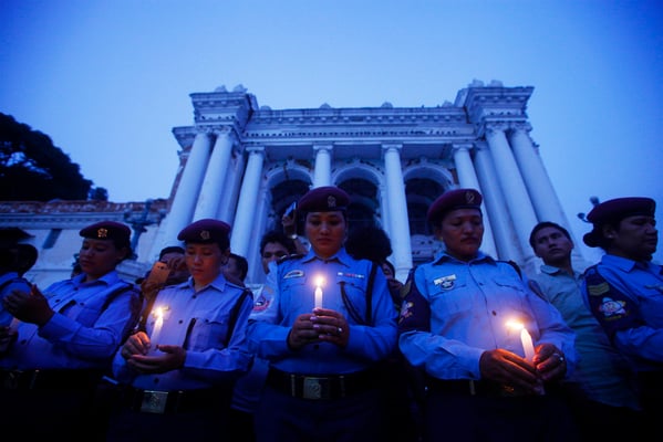 Nepal Police Wives Association organise a candlelight vigil for earthquake victims in Basantapur Durbar Square in Kathmandu on Monday.