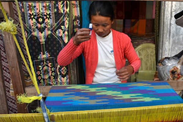 INTRICATE STUFF: A woman weaves a silk scarf at the hilltop viewpoint of Sarangkot in Pokhara.