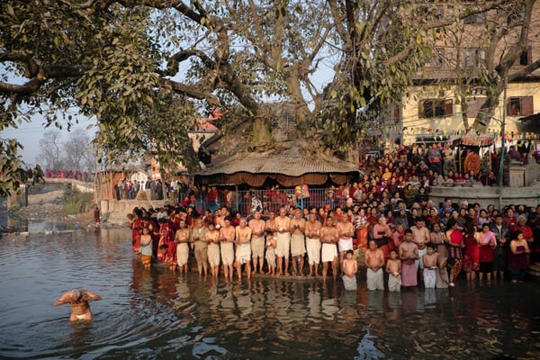 A Hindu devotee takes a dip in the holy water at the Hanuman Ghat in Bhaktapur on the last day of the month-long Swasthani festival.