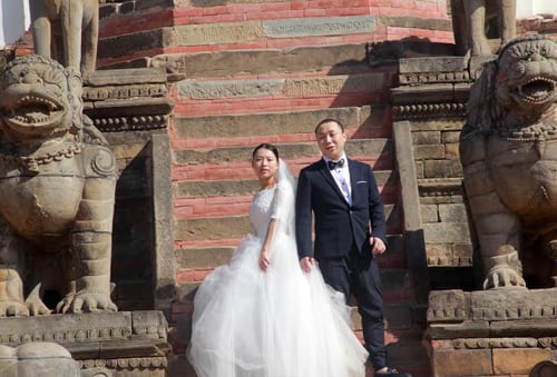 A Chinese couple pose for a photo in Bhaktapur durbar square on Tuesday. More Chinese tourists are visiting Nepal now than previous years.