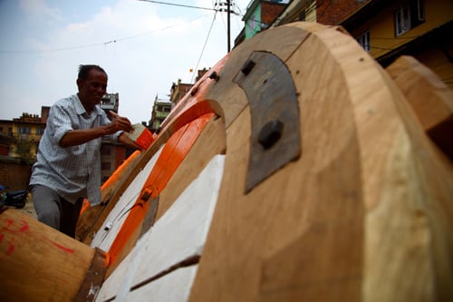 A man paints the wheel of Rato machindranath chariot in Lalitpur on Monday.