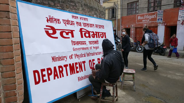 A painter prepares a new board for the Department of Railways in Patan Dhoka on Wednesday. Set up a few years ago, the department is now charged with surveying the alignment of the proposed East-West Railway and two cross-border railway lines linking Biratnagar and Janakpur to India.