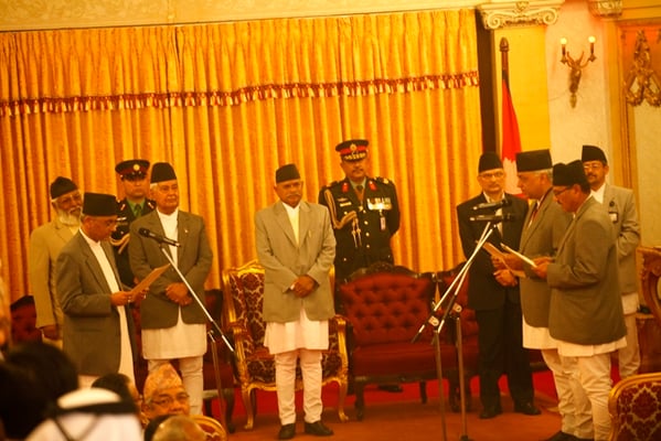 I DECLARE: The newly appointed chairman of interim electorate cabinet Chief Justice Khil Raj Regmi administers oath to the cabinet members Madhav Prasad Ghimire and Hari Prasad Neupane.