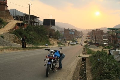 DELAY: A rider checks his engine after it suddenly stopped in the middle of the road in Banepa on Sunday evening.