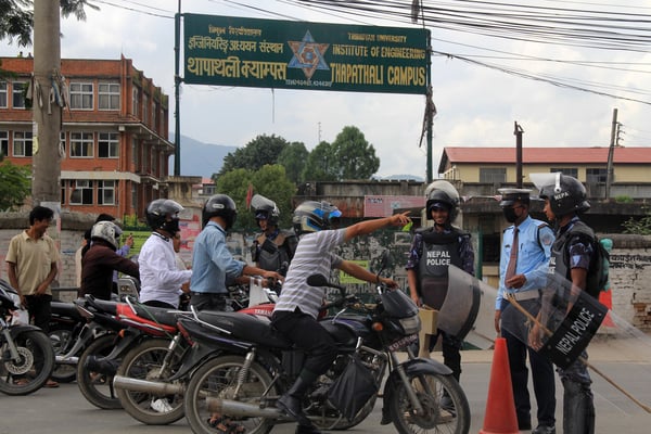 Motorcyclists wait for the traffic to resume, following Indian Prime Minister Narendra Modi's arrival in Kathmandu on Sunday.