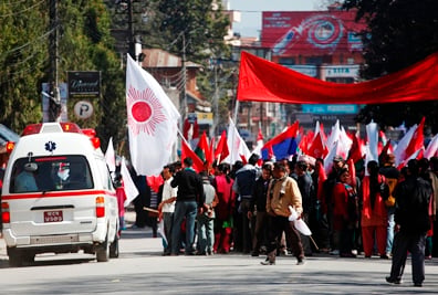 EXCUSE ME: An ambulance makes its way through an anti-government protest organised by nine opposition parties at Exhibition Road on Friday.