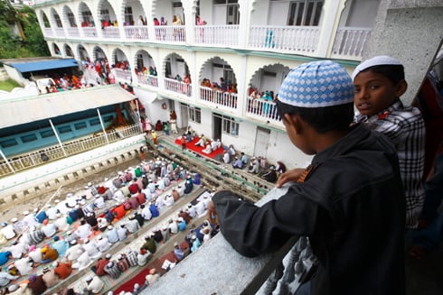 EID MUBARAK: Young Muslim boys looking at the mass prayers of Eid-al-Fitr at a mosque in Bagbajar on Friday.