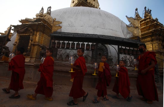 Buddhist monks circle around the Swayambhunath Temple during a candle light vigil to pray for the earthquake survivors on Wednesday.