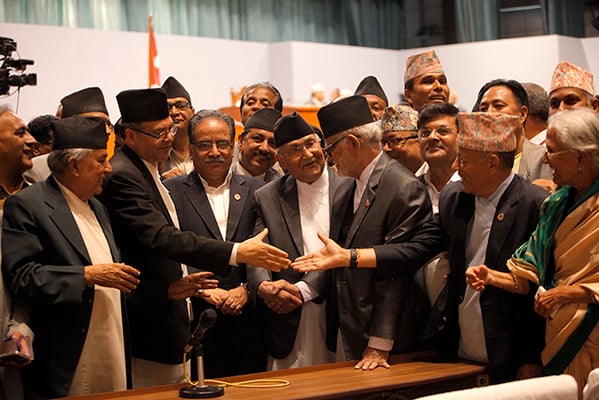 Prime Minister Sushil Koirala, UML Chairman KP Sharma Oli, UCPN(M) Chairman Pushpa Kamal Dahal and UML leader Jhalnath Khanal congratulate each other after the new constitution is passed on Wednesday night.