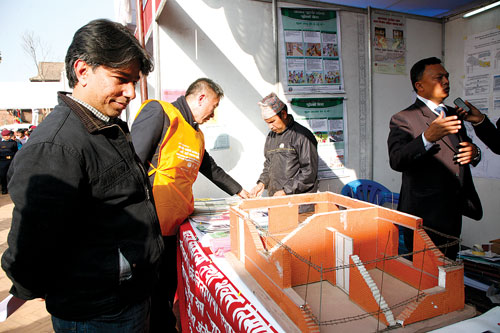SAFETY FIRST: Architect and sculptor Rabindra Puri (left) inspects a model of a reinforced house at Bhaktapur on Tuesday during a program to mark the 79th anniversary since the 1934 earthquake.