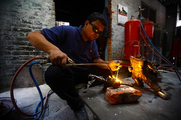 28-year-old Hari KC welds a statue at Lalitpur on Friday. The factory, which remained closed due to the fuel crisis, reopened after the end of the Indian imposed blockade.