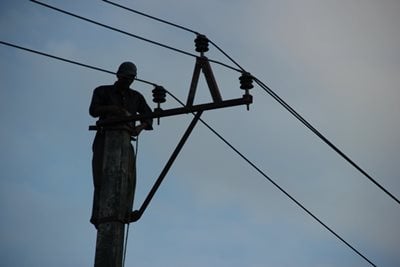 POWERFUL: Electricity company workers set new cable lines in Lazimpat as a part of road extension program on Saturday.