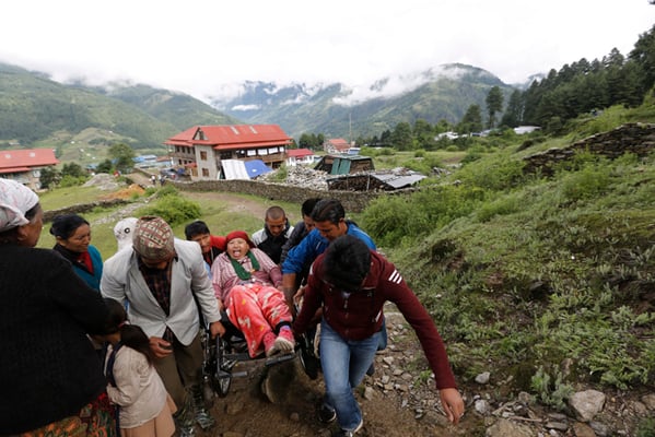 Villagers carry Dhan Kumari Tamang, 45 to the polling station in Solukhumbu on Wednesday. People in Province 1,5 and 7 are casting their votes for local representatives today.