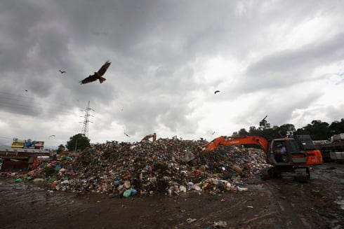 DIRT PILE: A crane loads garbage from Kathmandu's waste depot in Teku on Monday.