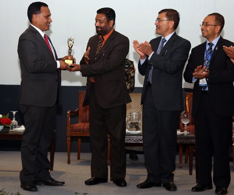 Nepal Electricity Authority (NEA)'s Managing Director Kulman Ghising (far left) receives the Best Contributor in the Infrastructure of the Year award from Home Minister Bimalendra Nidhi (second from left) on the last day of Nepal Infrastructure Summit that concluded on Monday in Kathmandu.